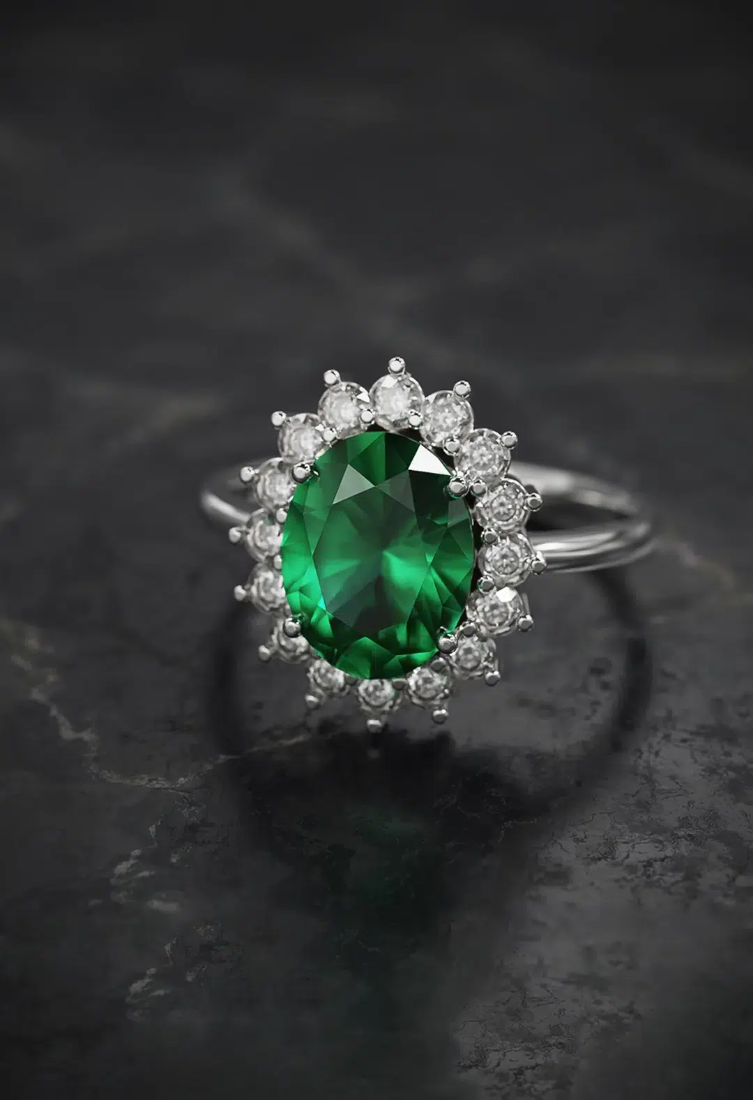 Emerald and diamond halo ring on hand