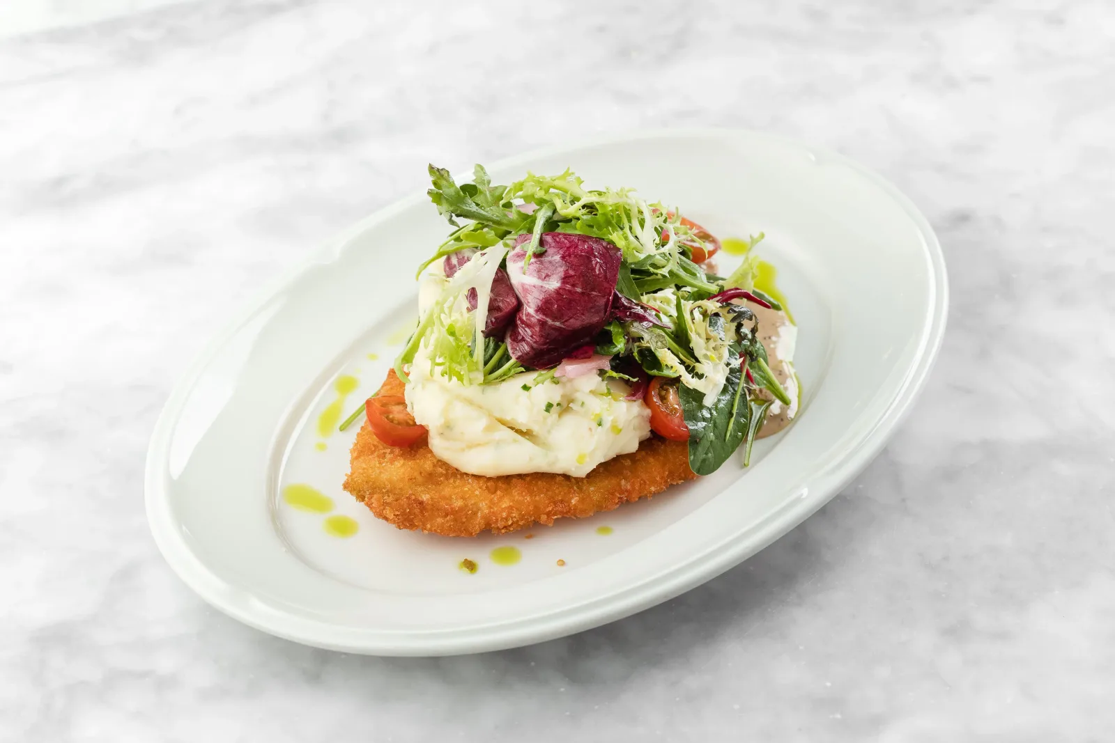 Breaded schnitzel topped with salad