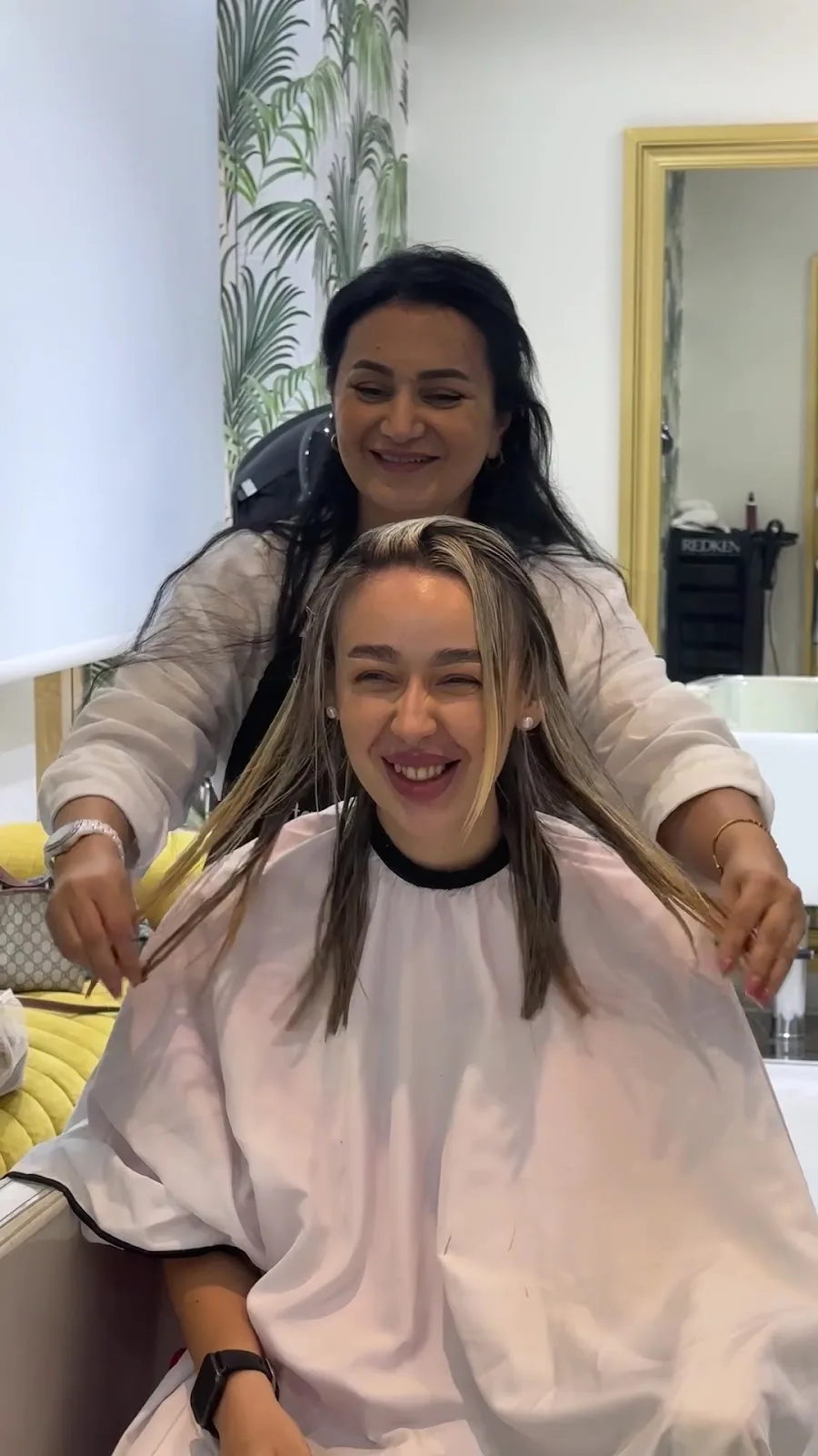 A stylist and a smiling client mid-appointment at M Le Diamant Beauty Lounge