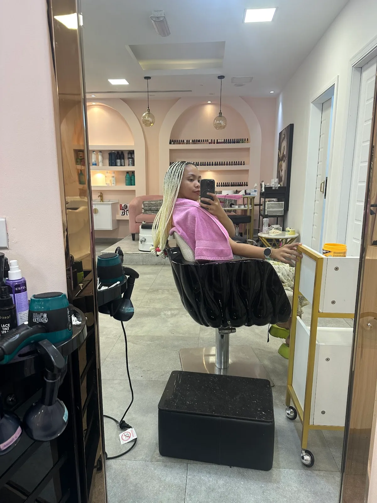 Inside Afroglam — soft pink salon with arched alcoves in Dorra Bay