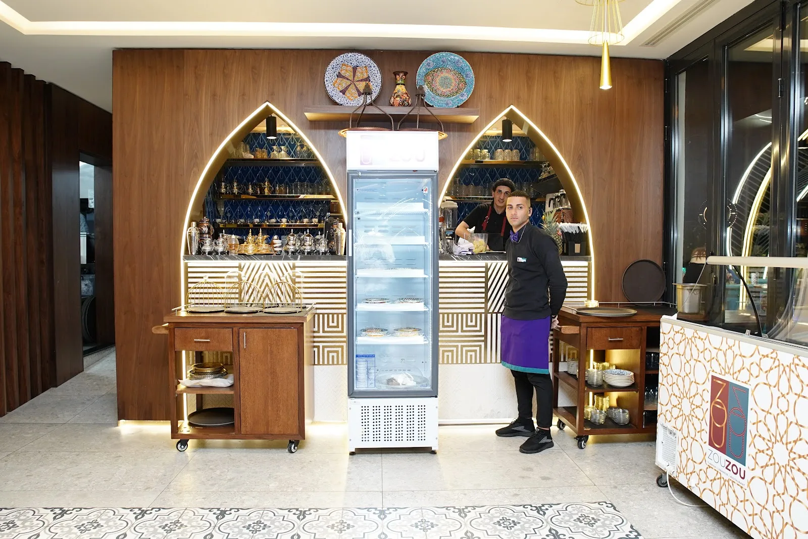 Bakery and dessert counter with arched alcoves and Turkish plates