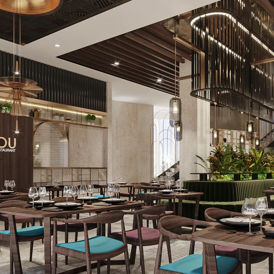 ZouZou dining hall with sculptural lighting, walnut tables and lush greenery