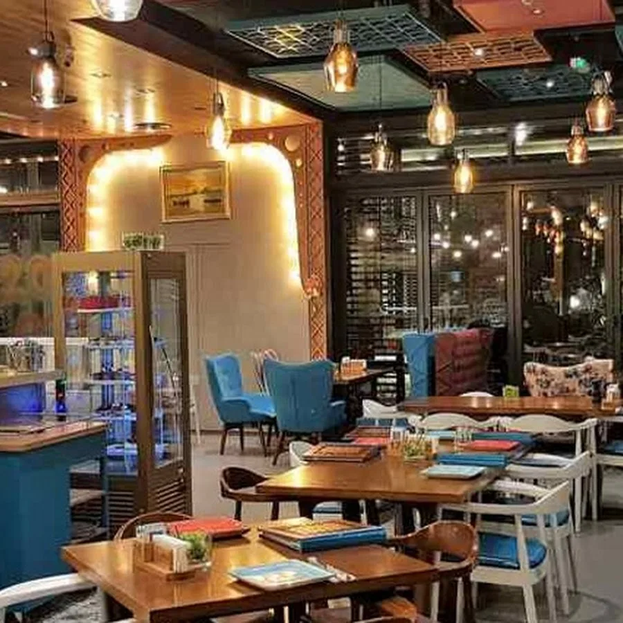 Warm dining room with pendant lights and blue chairs