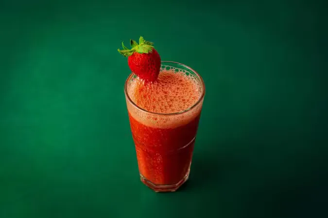 Fresh strawberry juice in a tall glass