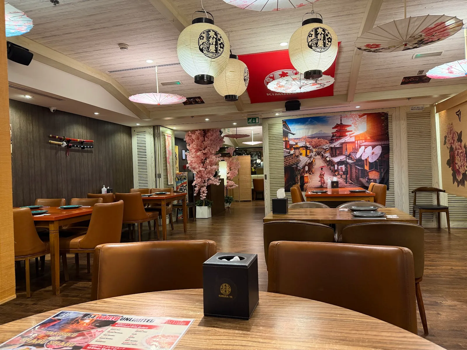 Kimuraya dining room with a Kyoto street mural, parasols and lanterns