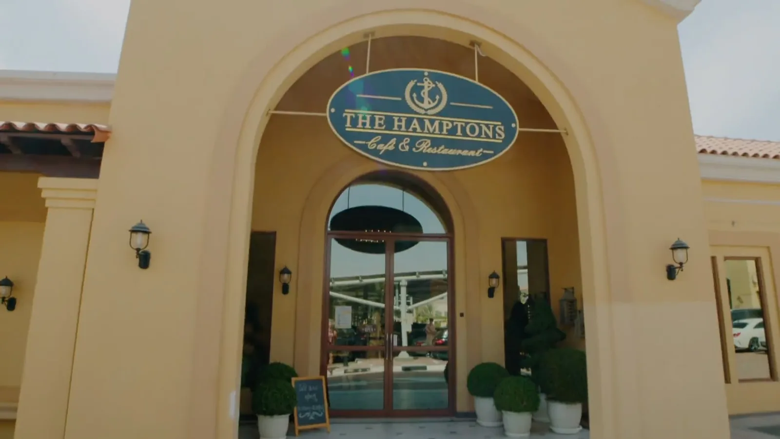 Arched entrance of The Hamptons with the nautical anchor signboard