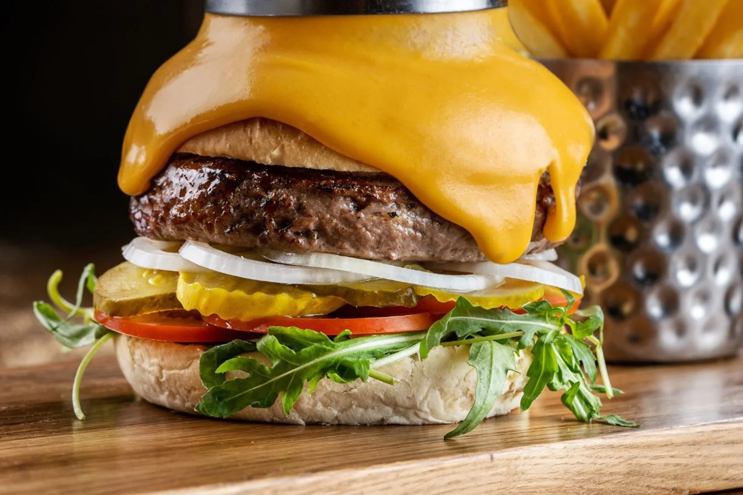 Cheeseburger with melted cheddar, pickles and fries