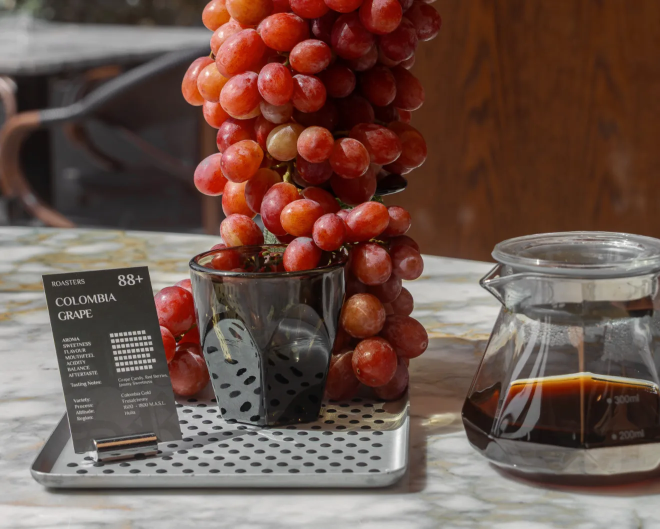 Filter coffee carafe beside a single-origin tasting card