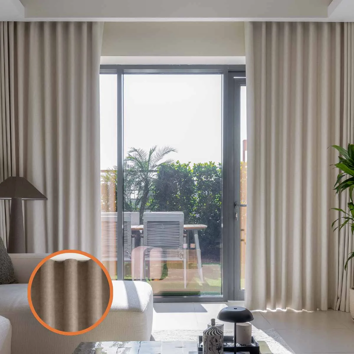 Floor-to-ceiling pinch-pleat drapes in a Dubai villa with a fabric swatch detail