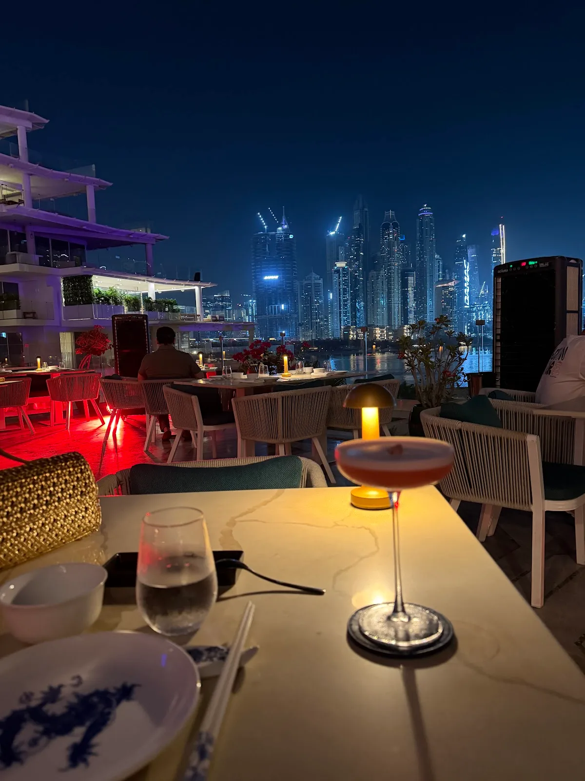 Cocktail on the terrace at night with city lights