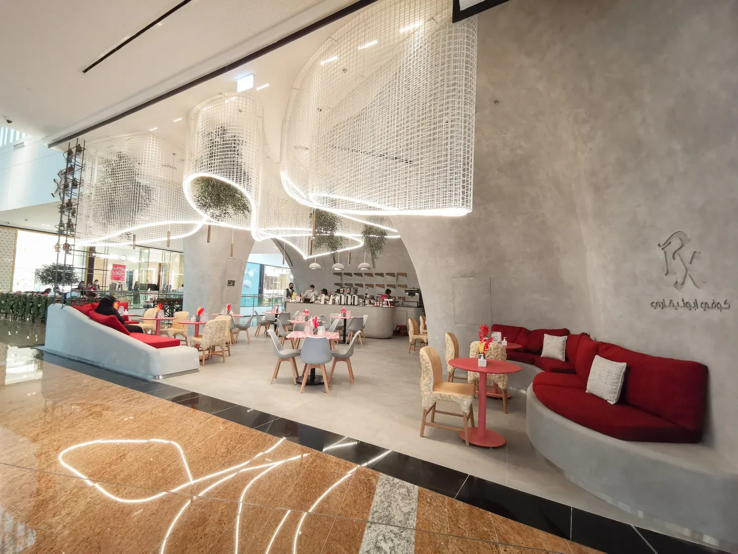 Concrete arches over lounge seating and the coffee counter