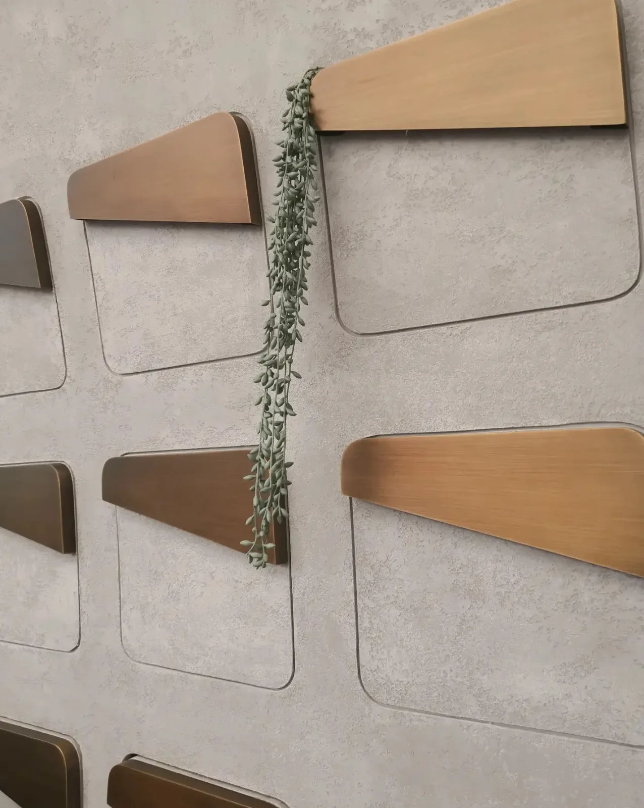 Detail of the timber apothecary drawer cabinetry with trailing greenery