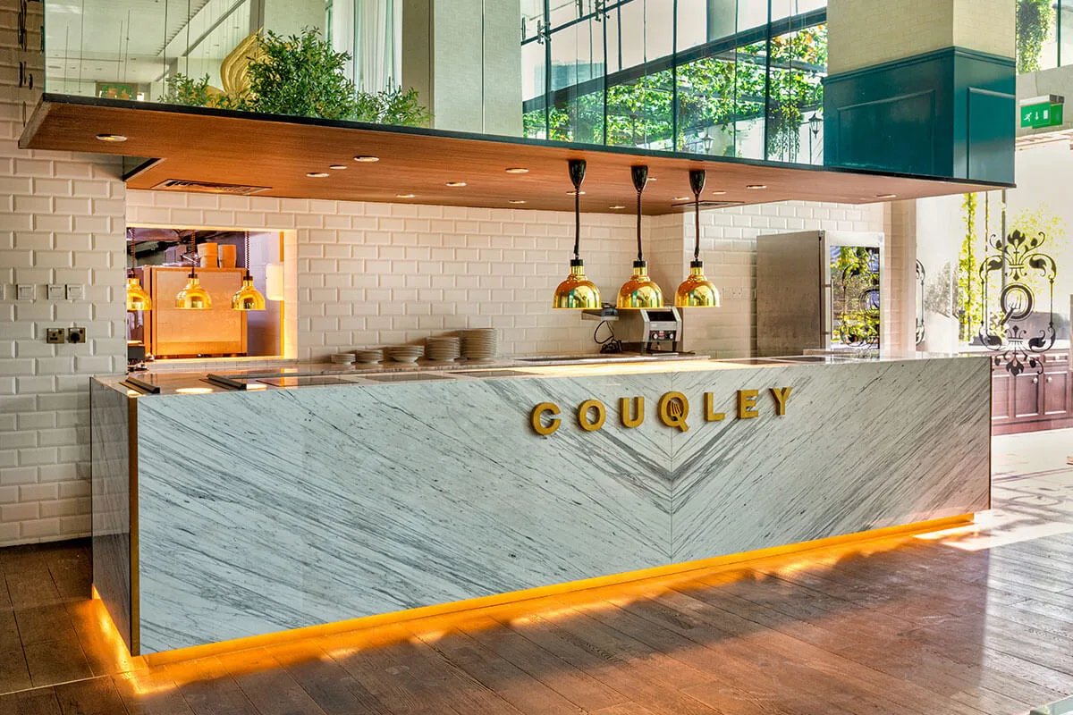 Marble COUQLEY bar pass with warm under-lighting