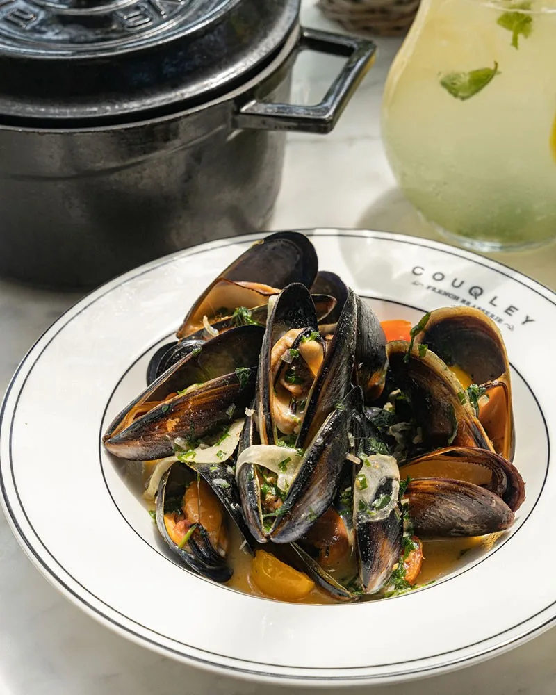Moules marinière in a white bowl