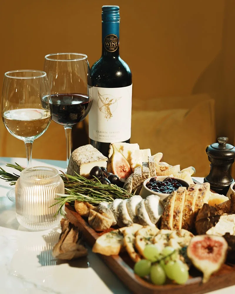 Cheese and charcuterie board with red and white wine