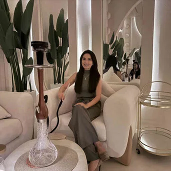 Guest relaxing with shisha in the soft-lit lounge at La Letizia