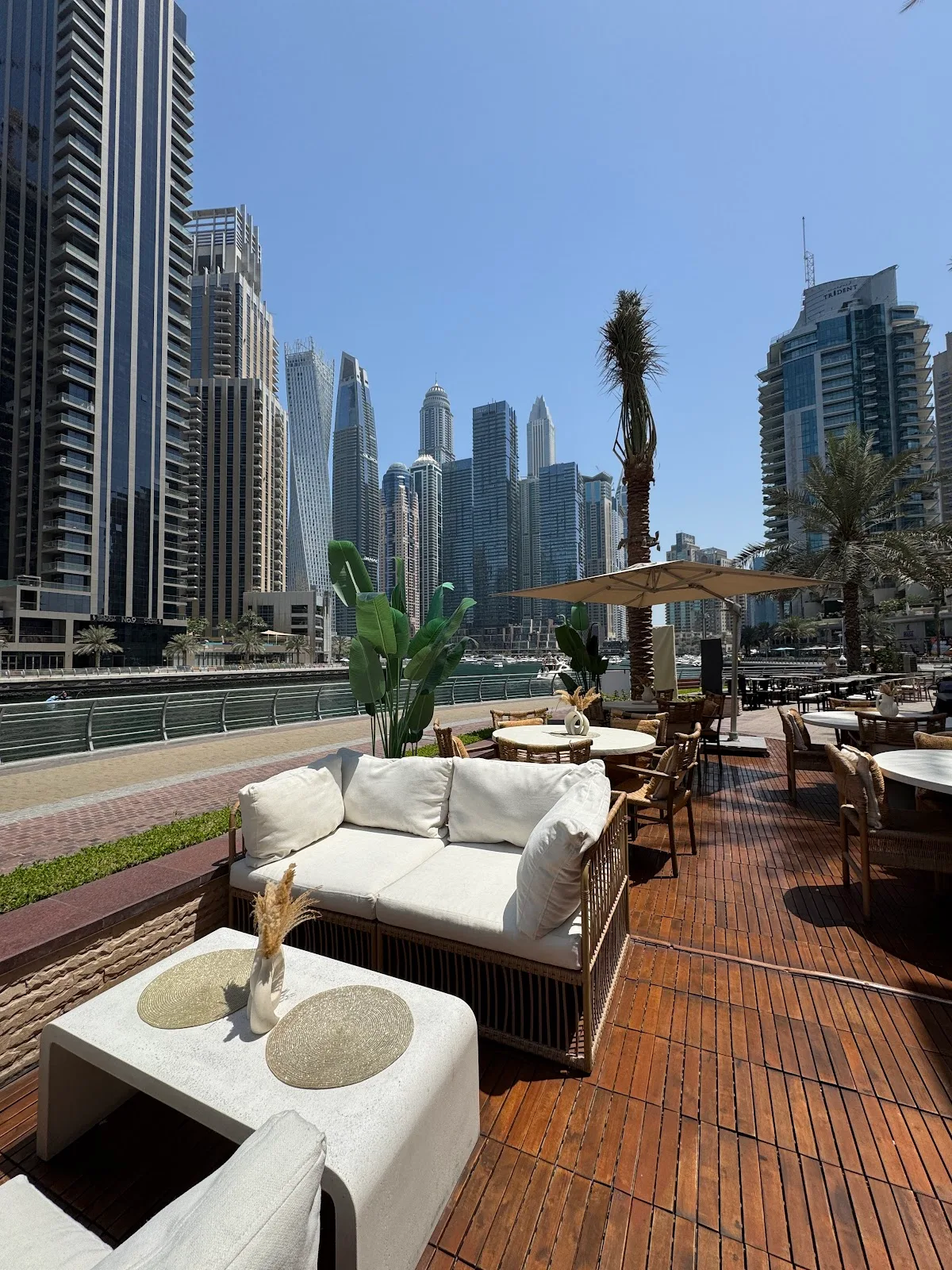Daytime terrace seating overlooking the marina and towers