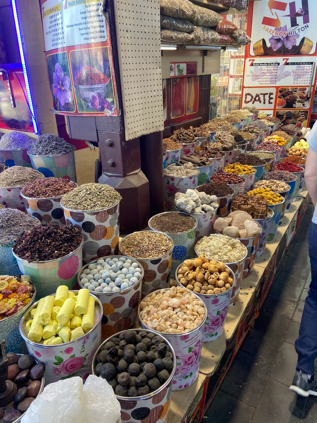 A perfume counter in the Deira souk, lined with attar bottles and oils