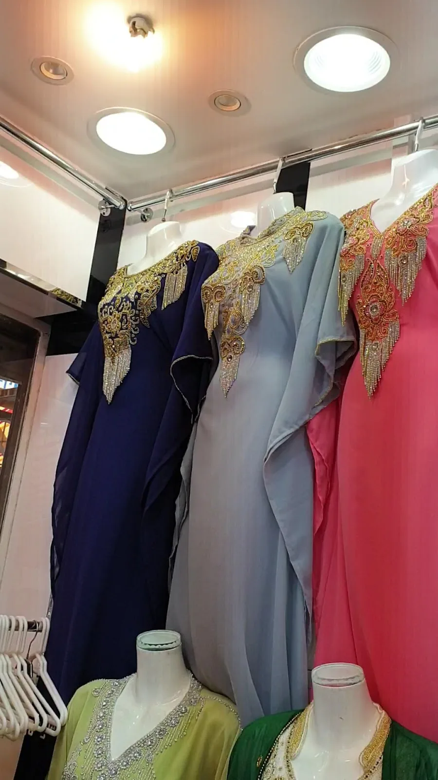 Embroidered kaftans on display in a Deira boutique