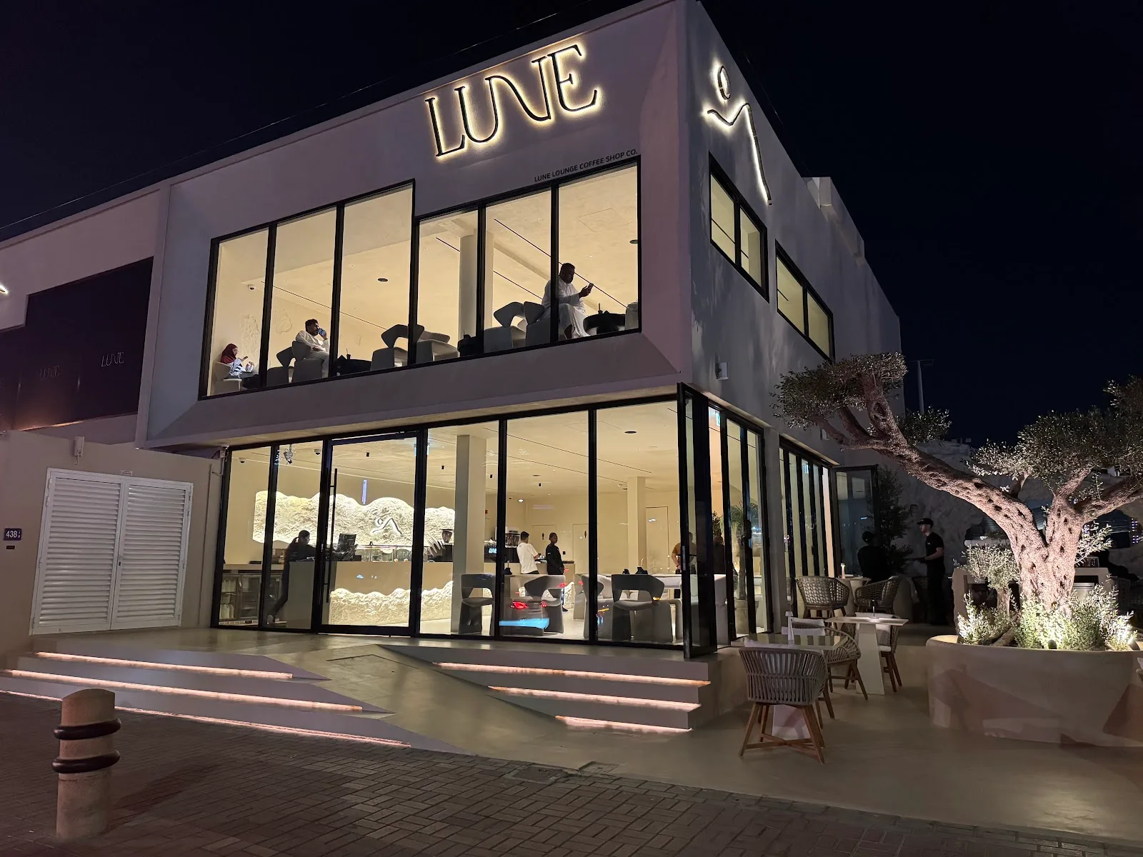 The illuminated LUNE building exterior at night.