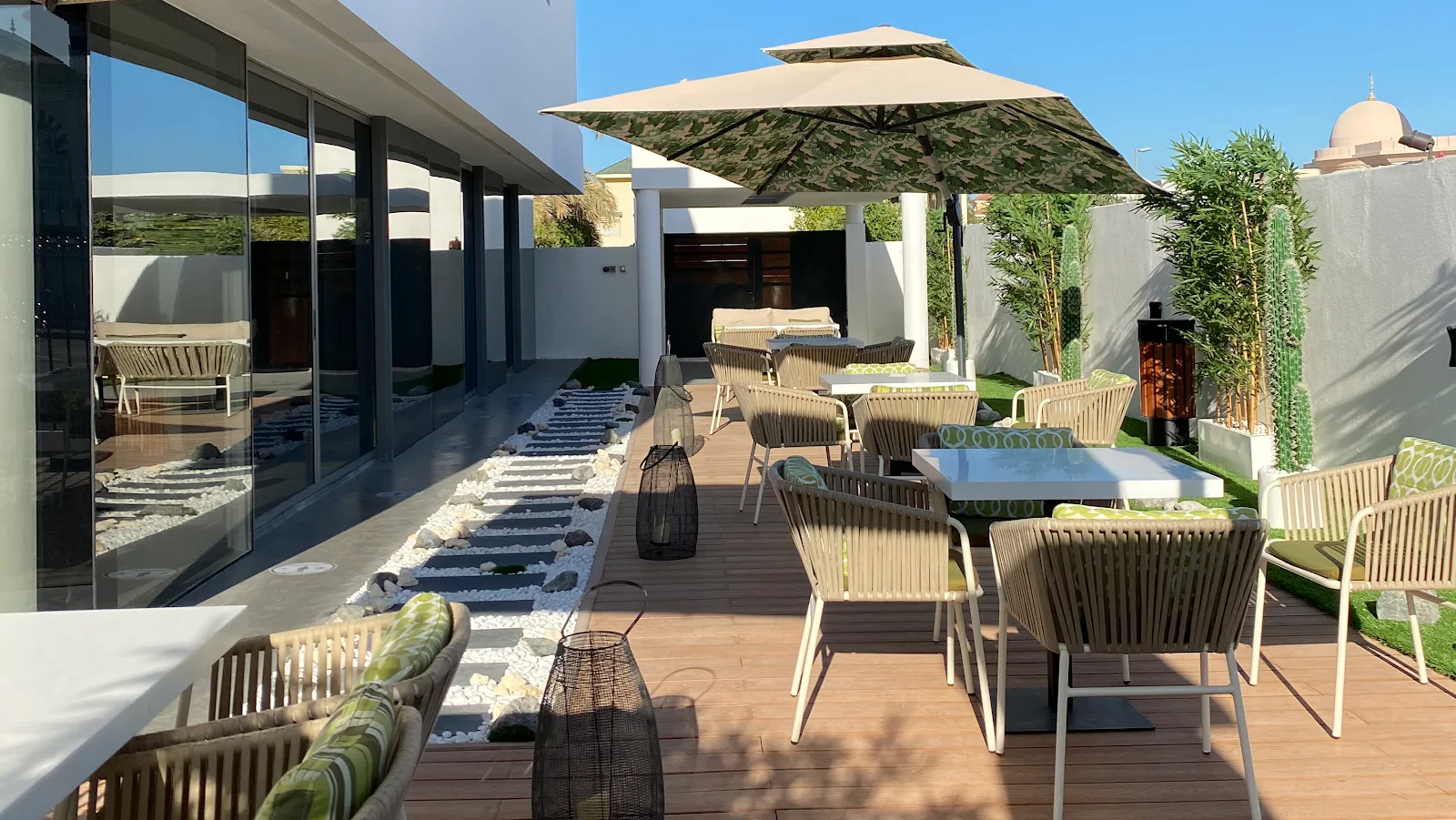Lune's daytime garden terrace with parasols and rope chairs.