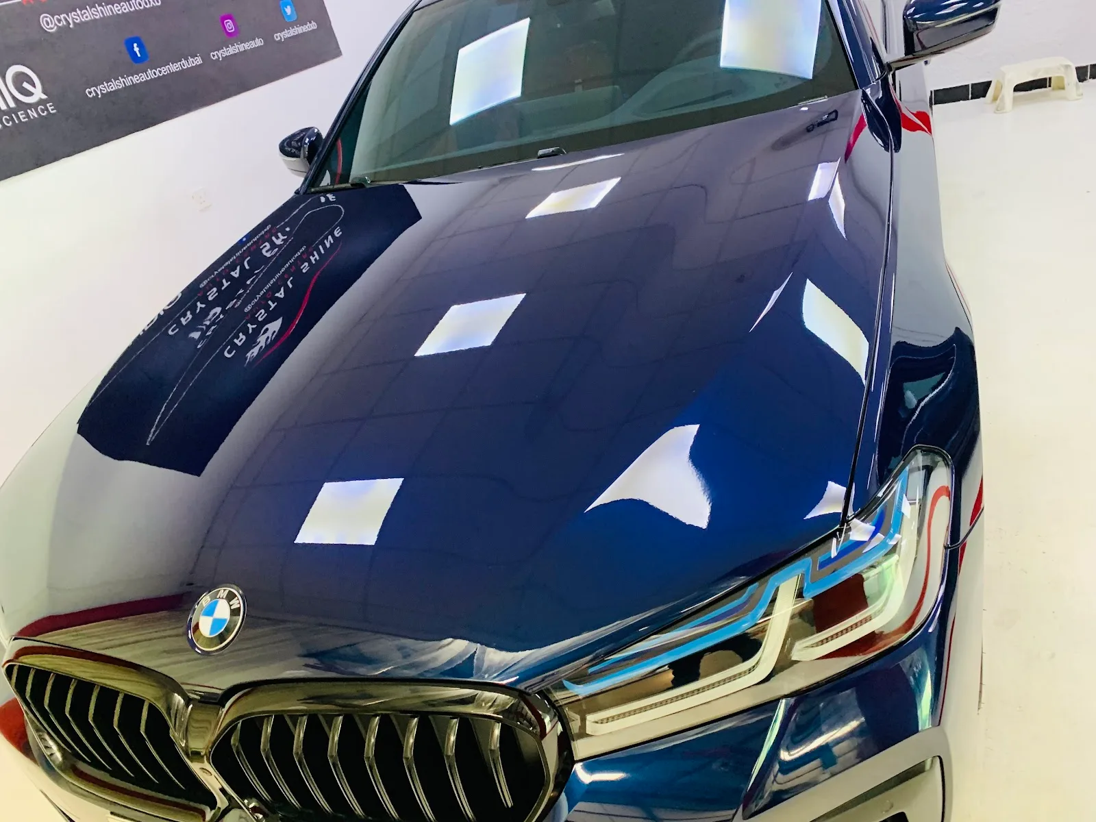 Blue BMW bonnet with mirror reflections after coating