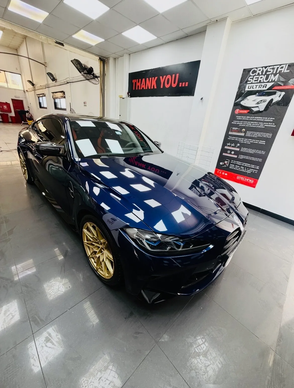 Blue BMW M4 with gold wheels detailed at Crystal Shine Car Care