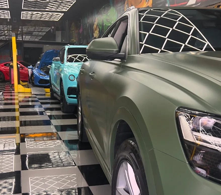 Detailed matte green SUV in the workshop
