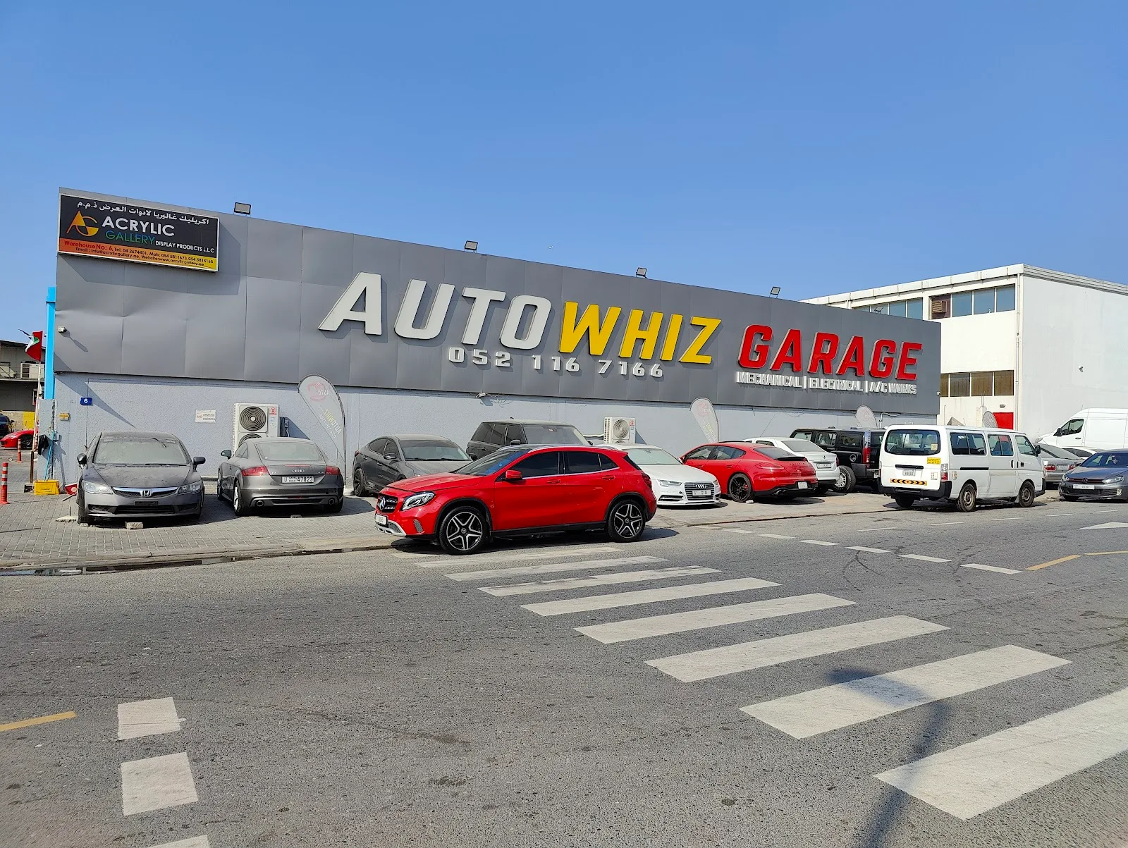 Auto Whiz Garage building exterior with cars parked outside