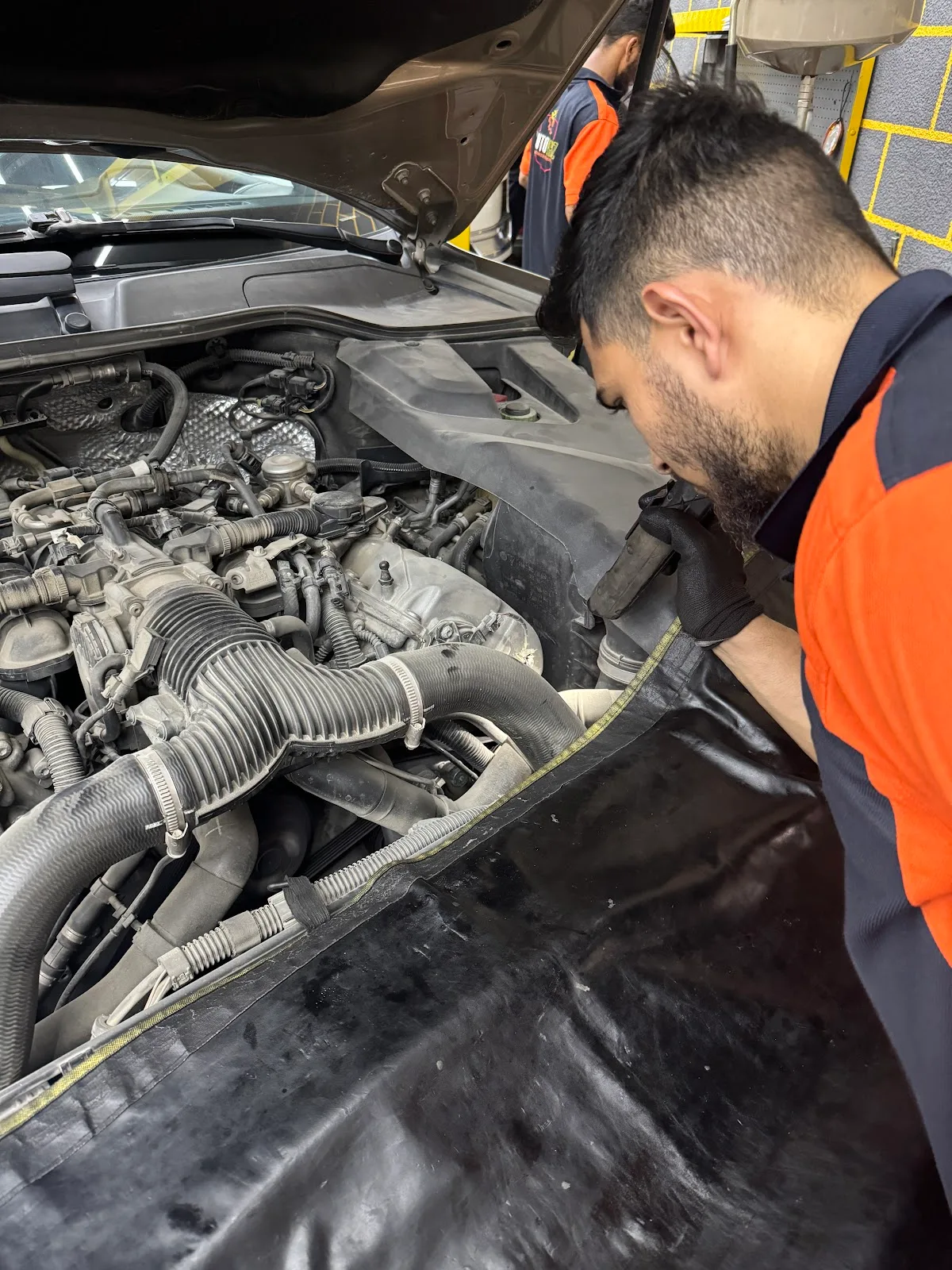 Technician inspecting an engine bay