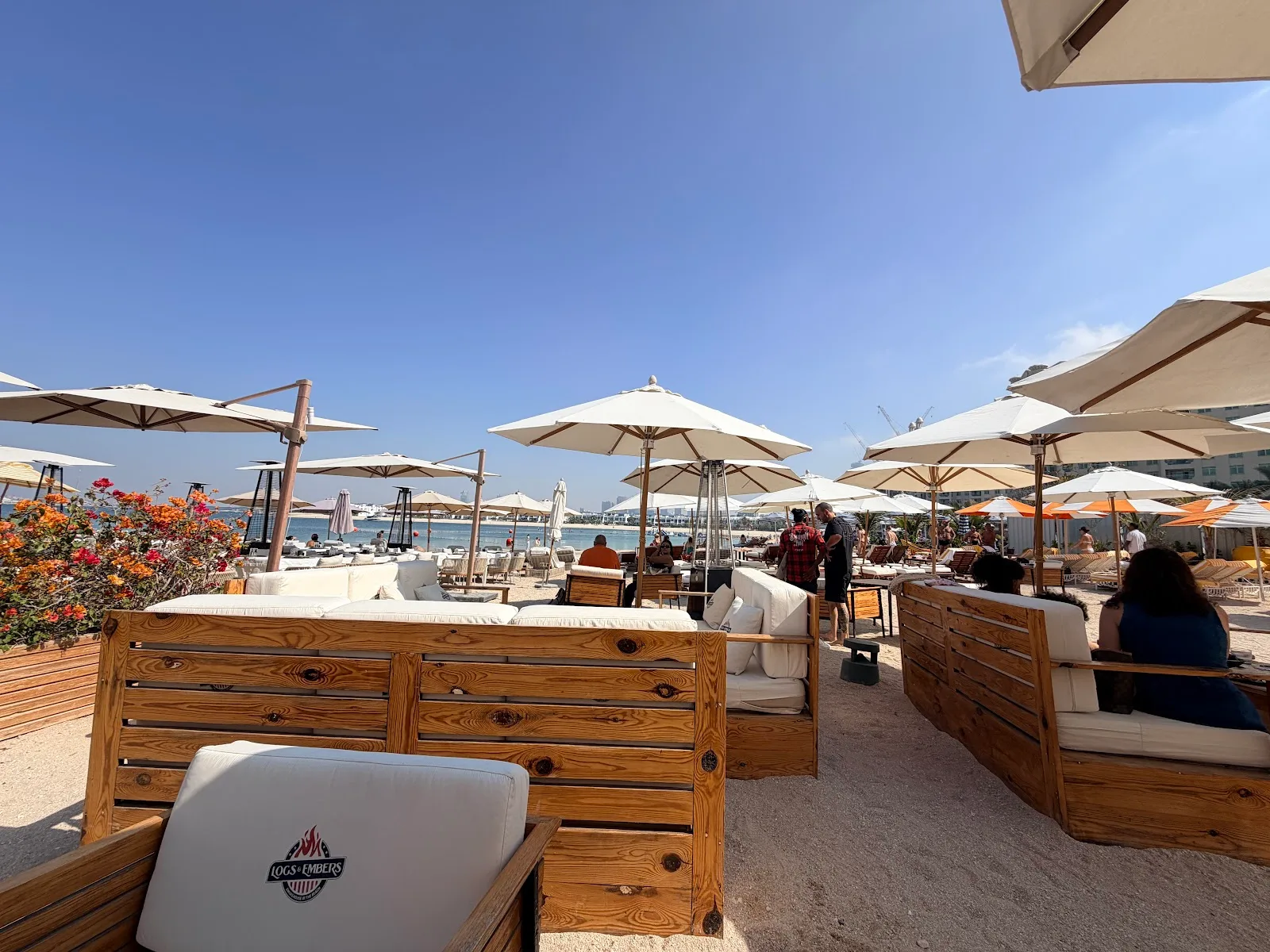 Beachfront loungers and umbrellas with sea views at Logs & Embers