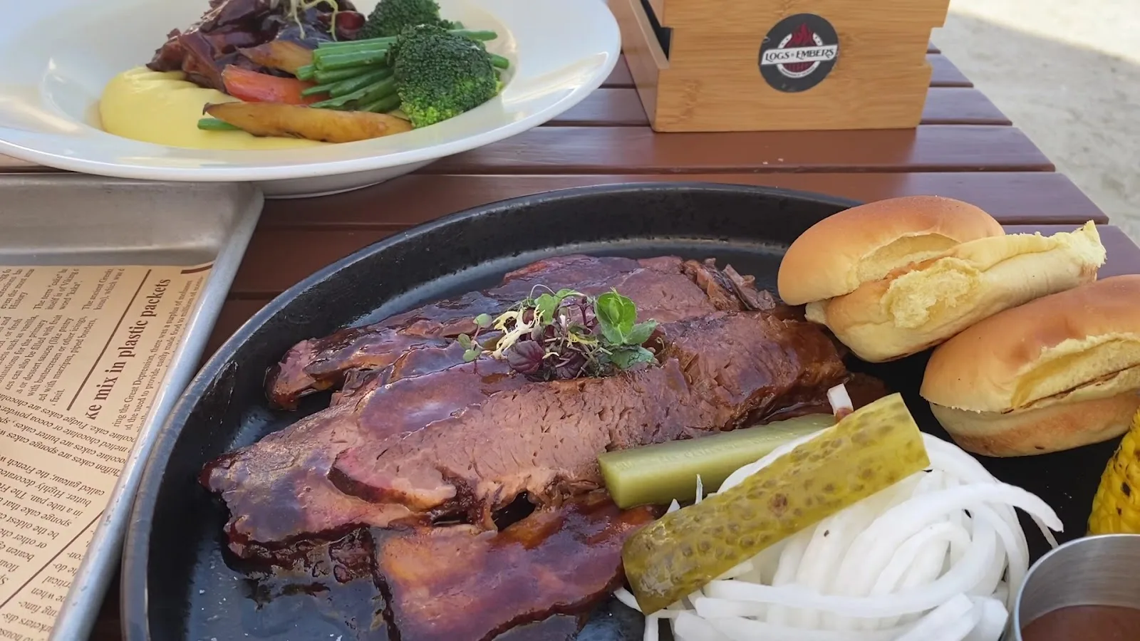 Sliced hickory-smoked beef brisket with pickles, onions and soft rolls