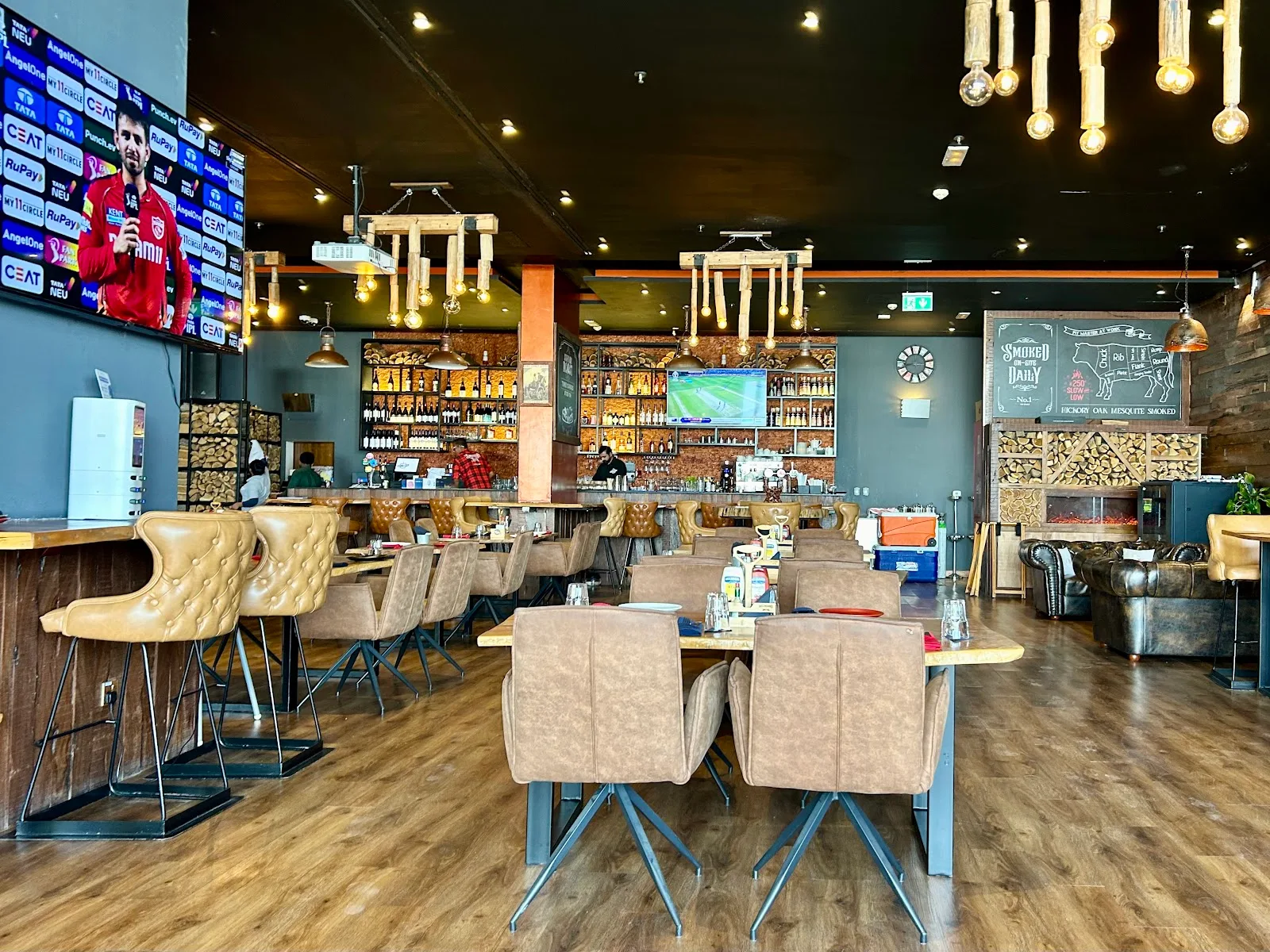 Interior bar with stacked firewood and warm lighting