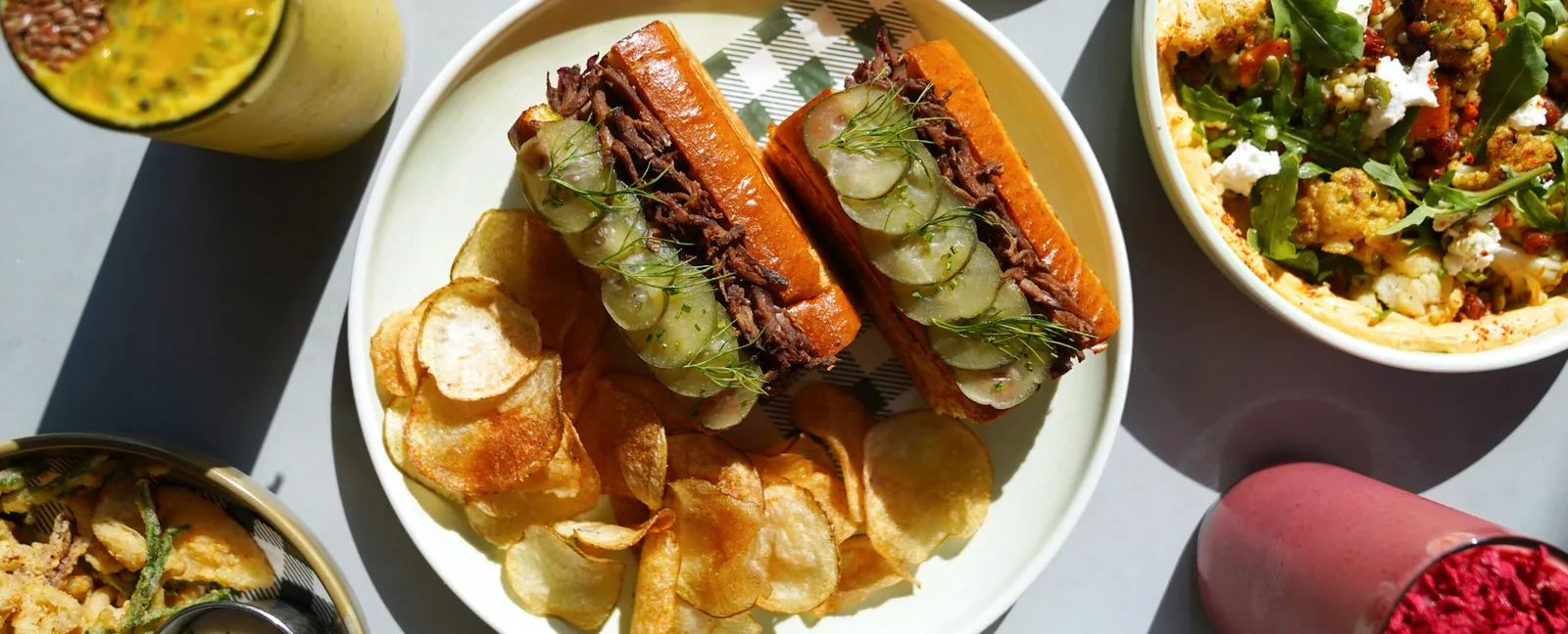 Slow-cooked brisket sandwich with house chips