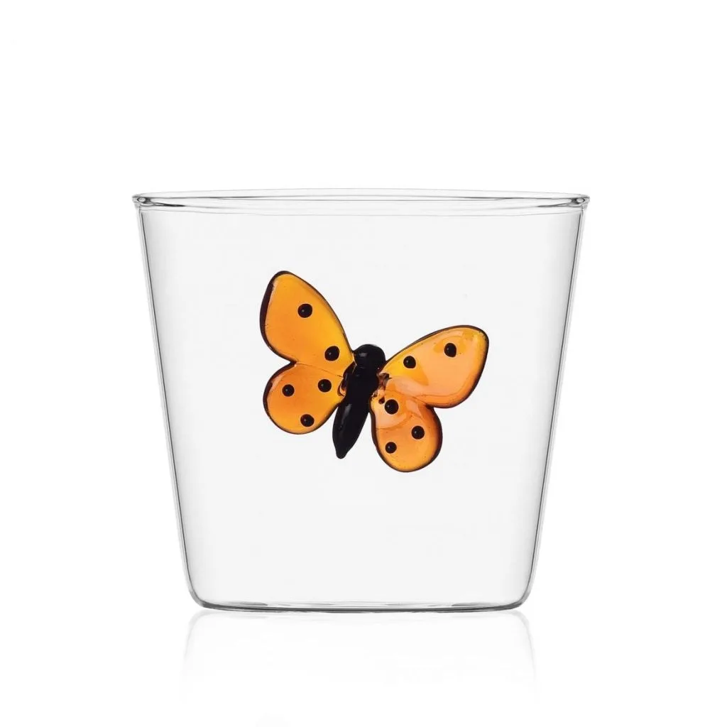 A clear tumbler with an amber glass butterfly motif.