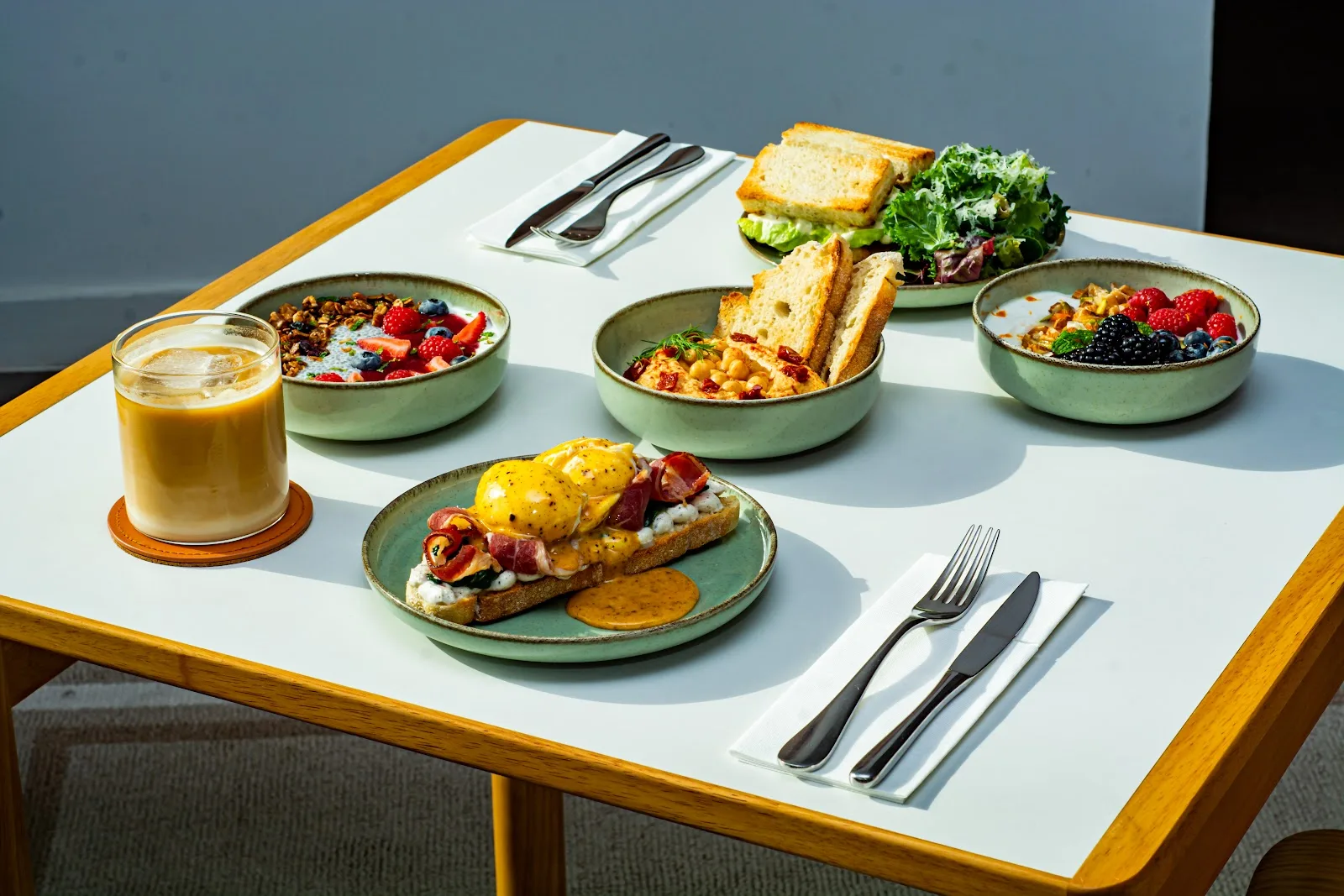 A spread of brunch plates and iced coffee