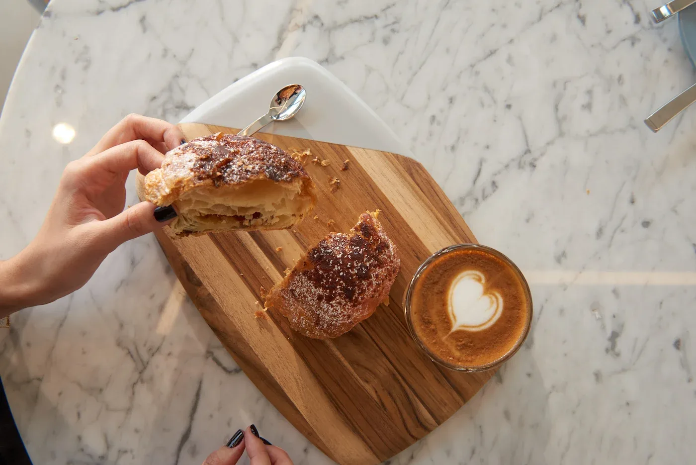 Croissant and latte on a marble table