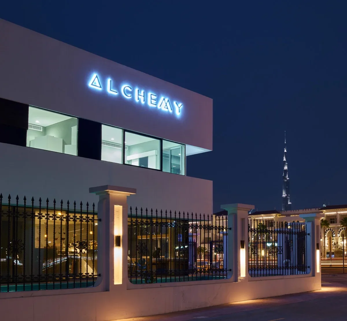 Alchemy Coffee exterior at night with the Dubai skyline