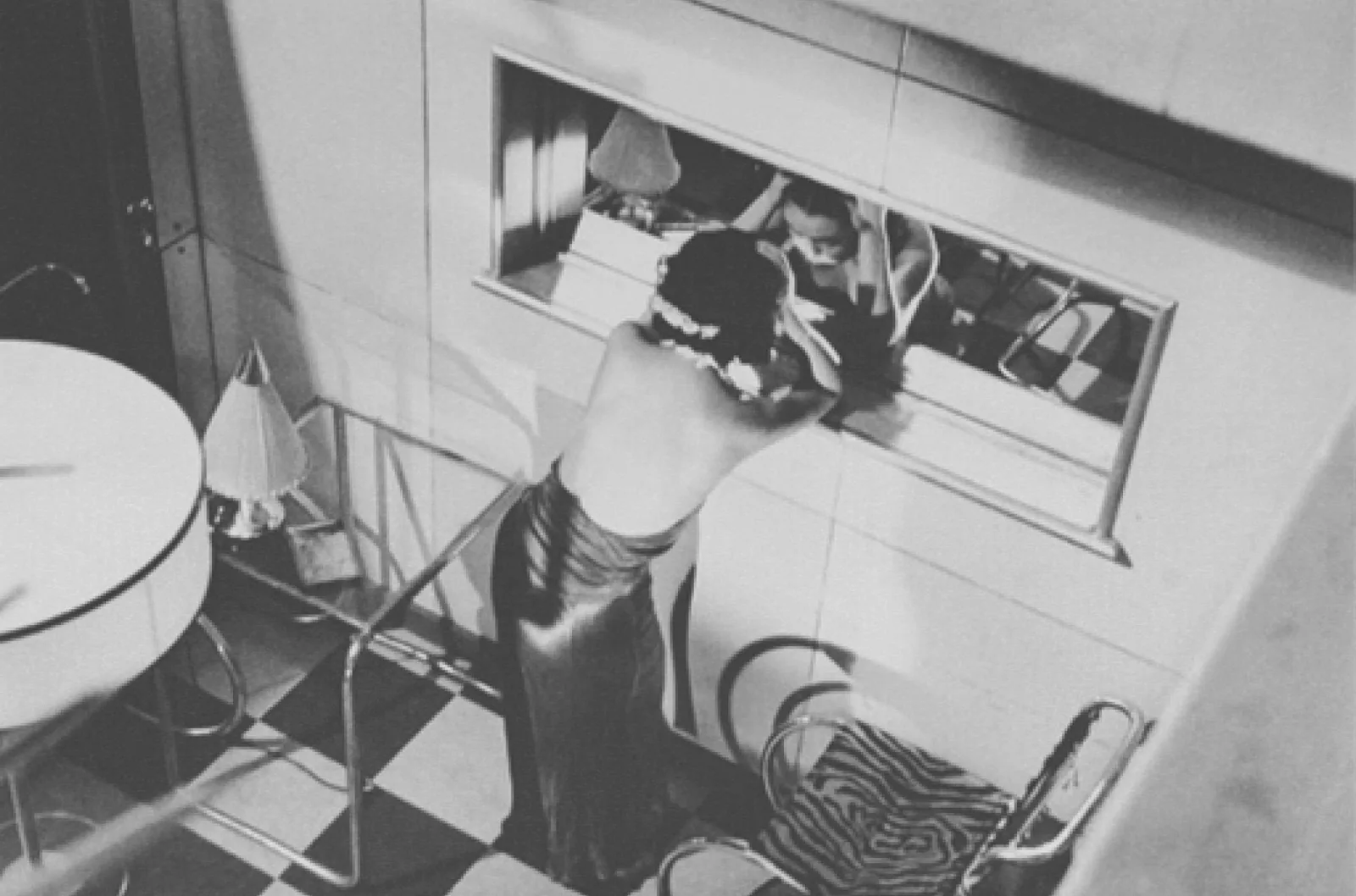 Vintage black-and-white scene of a figure at a bar