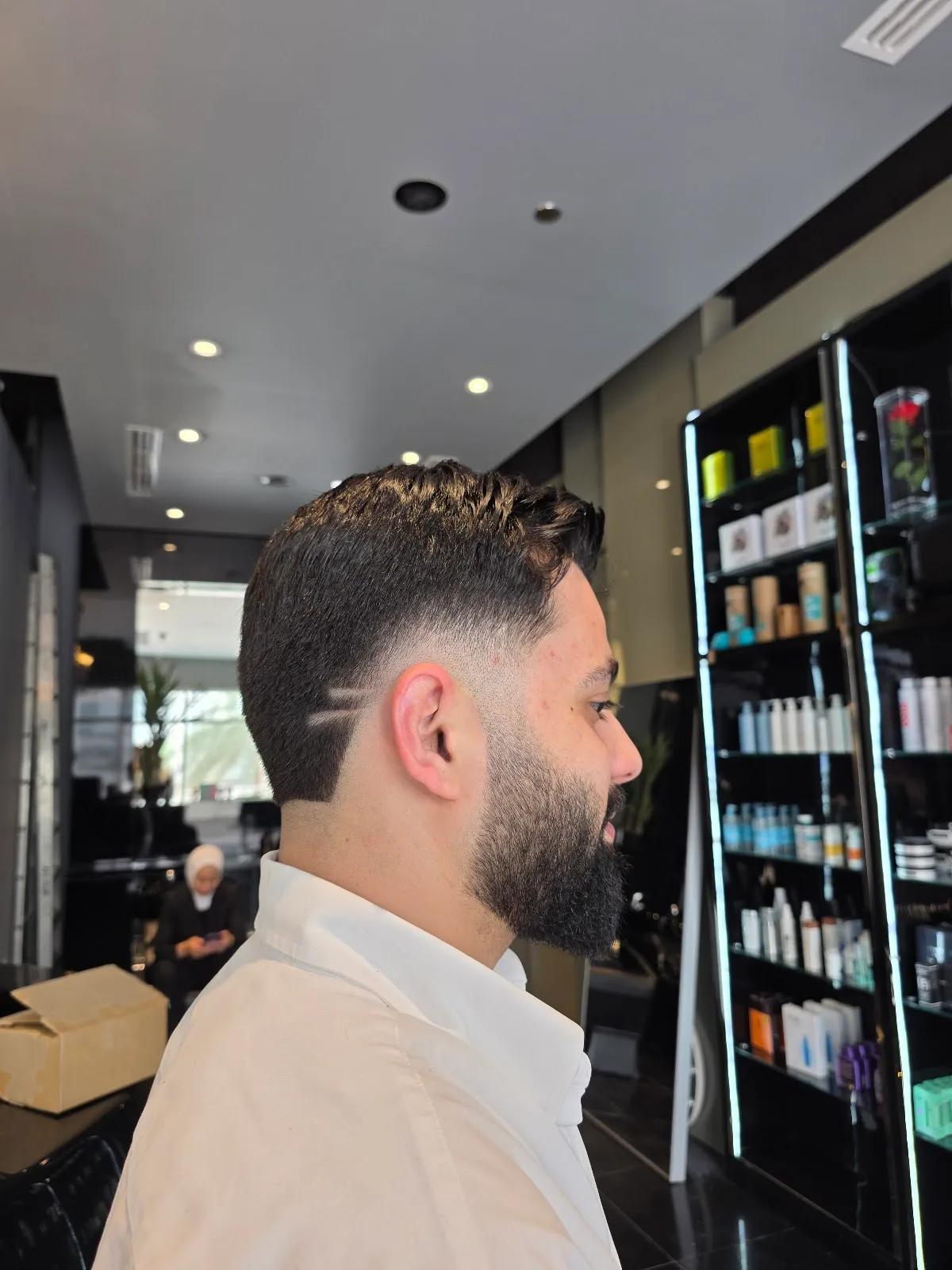 A clean skin-fade haircut and beard line-up