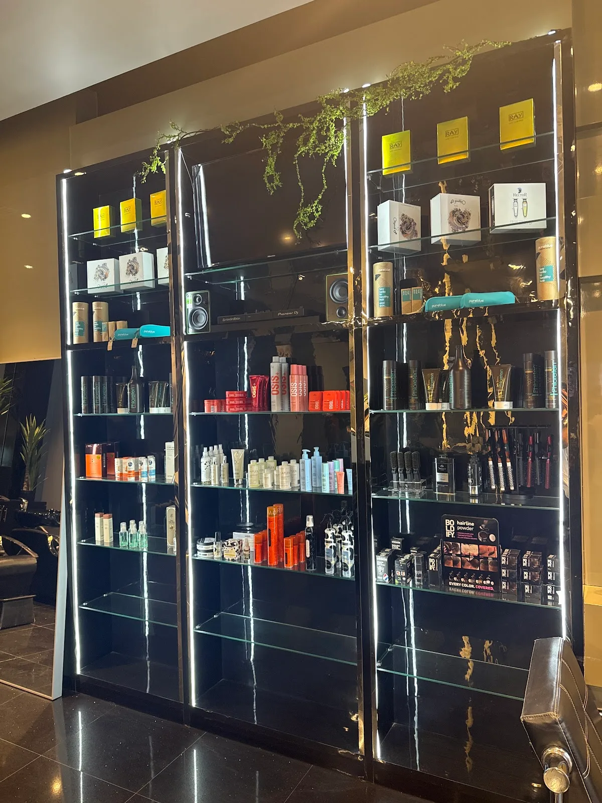 The polished product display wall inside The Gentlemen's Barber Shop - Dubai