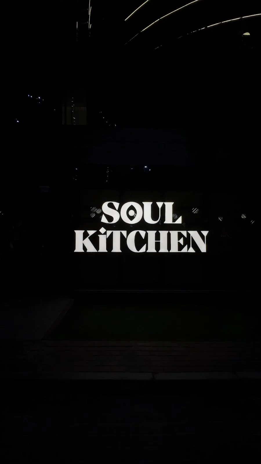 The illuminated Soul Kitchen sign at night