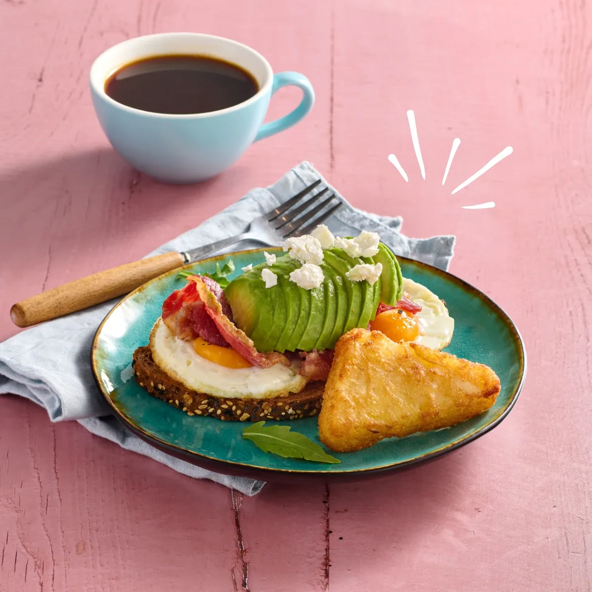 Avocado, bacon and egg breakfast on toast with a hash brown