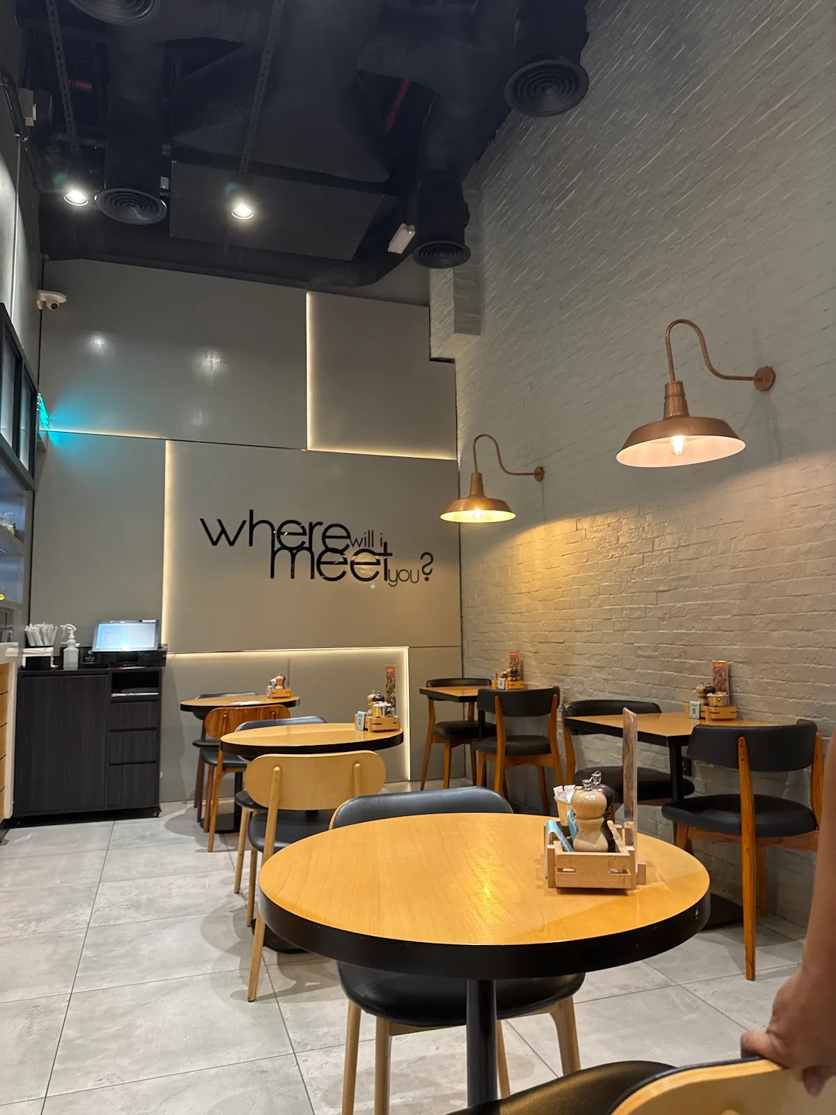 Café interior with timber tables and wall lettering