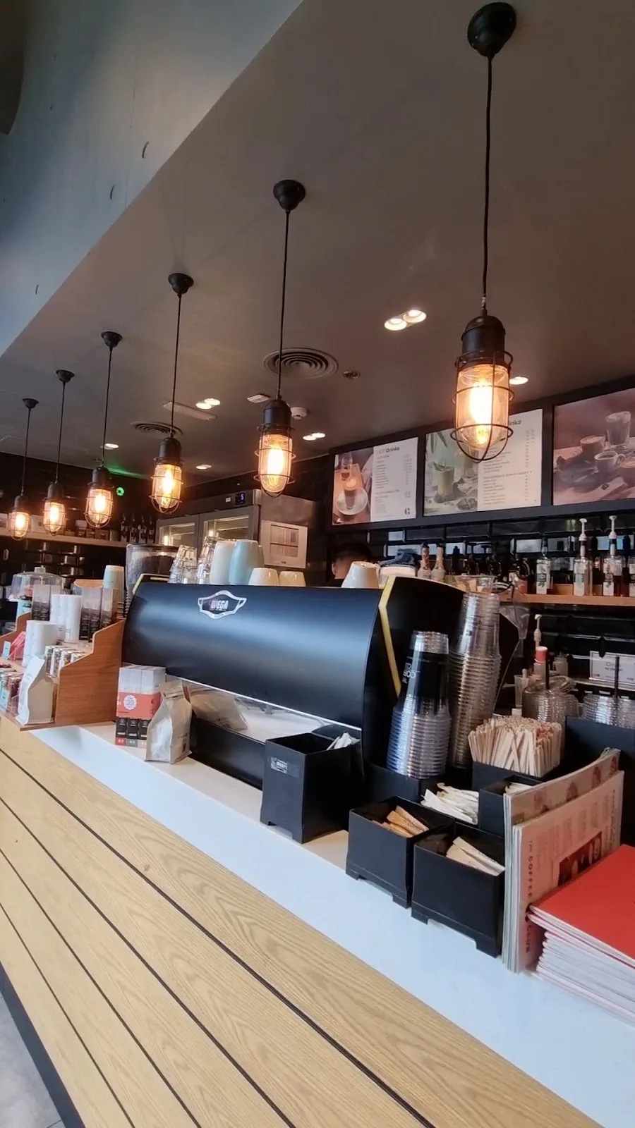 Café counter with pendant lighting and espresso setup