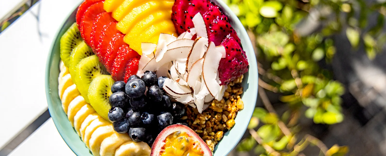 A vibrant açaí bowl topped with fresh fruit, coconut and granola