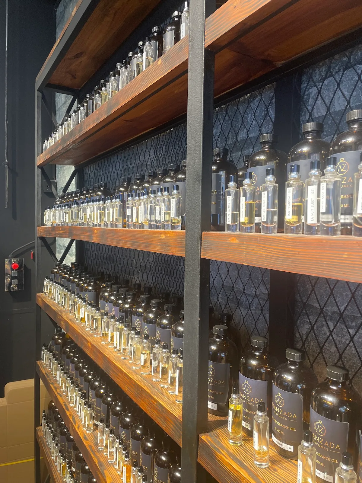 Wall of fragrance oil bottles in store