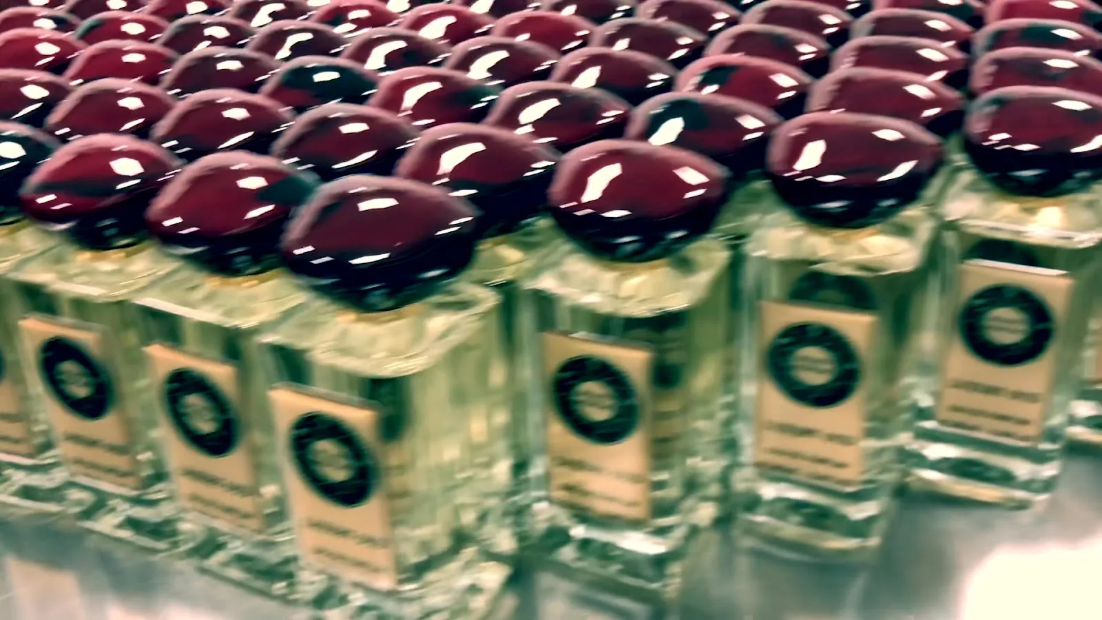 Rows of filled bottles with dark red caps
