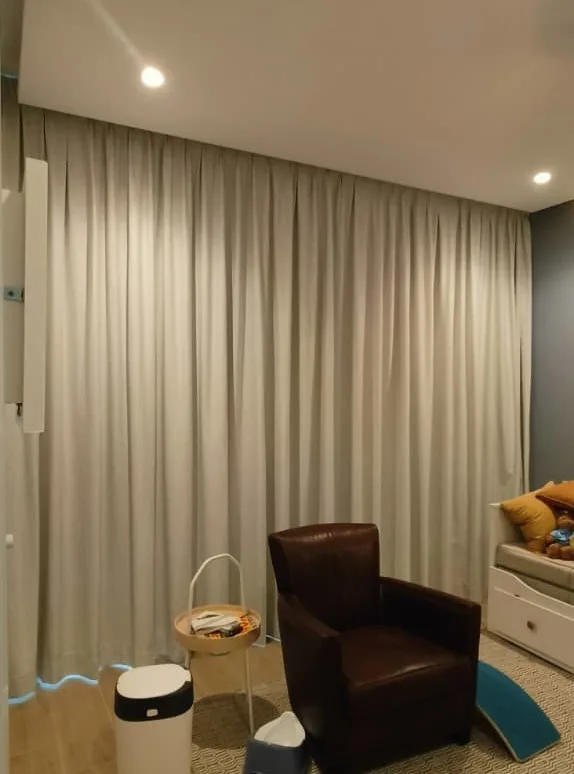 Soft grey full-length curtains in a cosy room