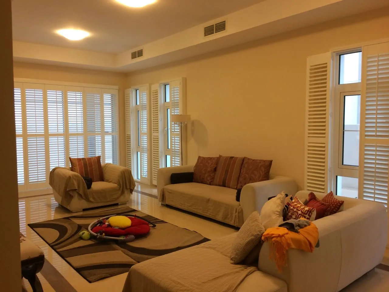 White plantation shutters across windows in a living room
